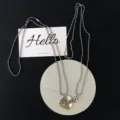 Detailed close-up shot of matching couple bead chain necklace with heart key pendant. - Key One (Two Pieces)