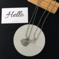 Detailed view of couple matching heart and key pendant necklaces with bead chains and love texts. - Key Two (Two Pieces)