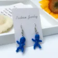Nahaufnahme von ausgefallenen blauen Babypuppen Ohrringen auf Displaykarte mit Details. - Haken-Stil / Saphirblau