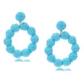 Detailed view of handmade light blue raffia woven circular earrings for summer vacation style. - Lake Blue