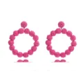 Detailed view of handmade pink raffia woven round statement earrings, bohemian beach style. - Wine Red