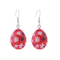 Detailed view of red Easter egg drop earrings with cute flower patterns and silver hooks. - Red Floral Egg Style (1)