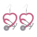 Close-up view of pink heart stethoscope wooden earrings, medical nurse theme jewelry detail. - Size 6