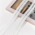 Closeup view of white hollow water-soluble lace trim, delicate embroidery fabric for DIY crafts. - Basic Style (AC4980) / 3.2cm