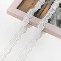 Detail shot of white polyester milk silk lace trim with hollow embroidery for DIY crafts. - Basic Style (AC4980) / 2.1cm