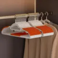 Household non-slip clothes hangers with double groove design in white and orange color. - Double Slot Hanger / Orange