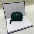 Monedero de cuero verde oscuro mini tarjetero con colgante de flor dorada y cierre de cremallera. - Verde