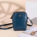 Dark blue leather small crossbody phone bag with floral metal snap and adjustable strap. - Blue