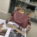 Detailed view of women's genuine leather shoulder bag featuring unique geometric design and strap. - Wine Coffee