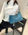 Detailed view of the stylish blue leather shoulder bag, elegant design for women daily use. - Blue