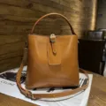 Vintage brown genuine leather bucket bag with top handle and crossbody strap for daily commute. - Sunset Yellow