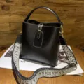 Classic black leather bucket bag with wide woven strap, vintage top handle shoulder bag. - Black