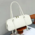 Detail view of a white leather cylindrical shoulder bag, featuring dual straps and sleek design. - 34*12*13 cm / Off White