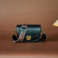 Vintage black leather saddle bag for women with colorful wide strap and chic bronze hardware. - Black