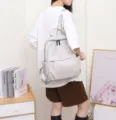 Detail view of a light grey genuine top layer cowhide leather travel backpack for women. - 27*14*34cm / Moon White