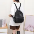 Black genuine leather backpack for women, stylish and lightweight travel daypack. - 27*14*34cm / Black