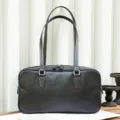Detail view of black leather shoulder bag, minimalist retro design with double straps and zipper. - Black