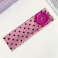 Pink polka dot stretch headband with a large purple button, stylish hair accessory for summer. - Pink