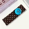 Chic brown polka dot headband featuring a large turquoise button, stylish hair accessory for women. - Coffee