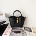 Black leather bucket bag with top handle and metal lock closure for women stylish daily wear - Black