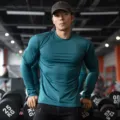 Detail view of men long sleeve athletic gym t shirt in dark green fitted slim solid color. - M / Tops / Round Neck Dark Green