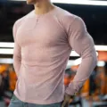 Detailed close-up shot of mens ribbed long sleeve slim fit t-shirt with button collar. - Henley Pink
