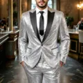 Detailed view of the sparkling silver sequin fabric and black satin lapel on suit jacket. - Silver