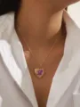 Close-up detail of a handmade heart locket necklace with purple dried flowers on model. - Purple Dried Flower (A)