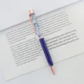 Elegant ballpoint pen with blue dried flowers in floating oil, rose gold accents - 1.0mm Bullet Tip / Transparent Blue