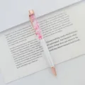 Close-up of elegant rose gold ballpoint pen with pink dried flowers in oil barrel. - 1.0mm Bullet Tip / White (Rose Flower)