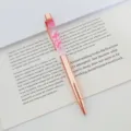 Close-up of rose gold metal ballpoint pen featuring elegant dried flowers in oil - 1.0mm Bullet Tip / Rose Gold (Rose Flower)