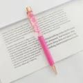 Elegant pink ballpoint pen featuring real pink dried flowers in clear oil-filled chamber. - 1.0mm Bullet Tip / Light Rose Red