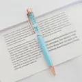 Elegant light blue ballpoint pen with blue dried flowers in floating oil and rose gold accents - 1.0mm Bullet Tip / Light Blue