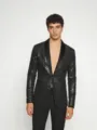 Vista detallada de la chaqueta de traje negra con lentejuelas para hombre con solapa chal. - Negro