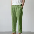 Detailed view of casual linen trousers in green, featuring relaxed fit and side pockets. - S / Green