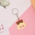 Leuke cartoon meisje sleutelhanger PVC zacht rubberen sleutelring tas hanger stijlvol cadeautje - 5,5*3,5*0,3 cm / Nieuw binnen - Bruine strik