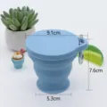 Portable 180ml collapsible silicone travel water cup with metal carabiner for outdoor use. - Blue