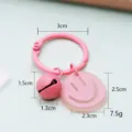 Leuke roze smiley sleutelhanger met bel, macaron stijl metalen ring en schattige tas hanger gift - Stijl met bellen / Roze Smiley