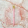 Pink metal ballpoint pen featuring a large crystal diamond top on a marble background - 1.0mm Bullet Tip / Pink