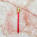 Red polka dot metal ballpoint pen featuring a large faceted crystal diamond on the top - 1.0mm Bullet Tip / Red Barrel with White Polka Dots