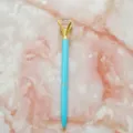 Cyan metal ballpoint pen with a large crystal diamond top on pink marble background - 1.0mm Bullet Tip / Blue