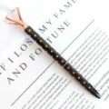 Elegant black and gold polka dot metal ballpoint pen with a large crystal diamond top - 1.0mm Bullet Tip / Black Barrel with Rose Gold Polka Dots