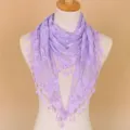 Detail view of the elegant purple lace triangle scarf with delicate floral patterns and fringe. - Light Purple