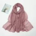 Detailed shot of mauve crinkled linen scarf with frayed edges, soft texture and elegant drape. - Leather Pink