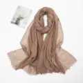 Detailed view of the cotton linen crinkled scarf featuring soft texture and frayed edges. - Khaki