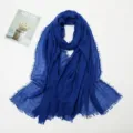 Detailed view of the blue crinkled cotton linen scarf featuring stylish fringe edges. - 16# Sapphire Blue