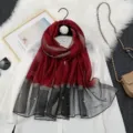 Detailed view of the elegant red and black gradient sheer scarf featuring delicate pearl embellishments. - Dark Wine Red