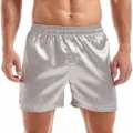 Close-up view of men's silver satin boxer shorts, smooth silky texture with elastic waistband. - Gray