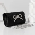 Black glitter evening bag with rhinestone bow and silver chain strap for women party. - Black