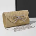 Sparkling gold glitter evening clutch bag with rhinestone bow and chic chain strap for women. - Champagne